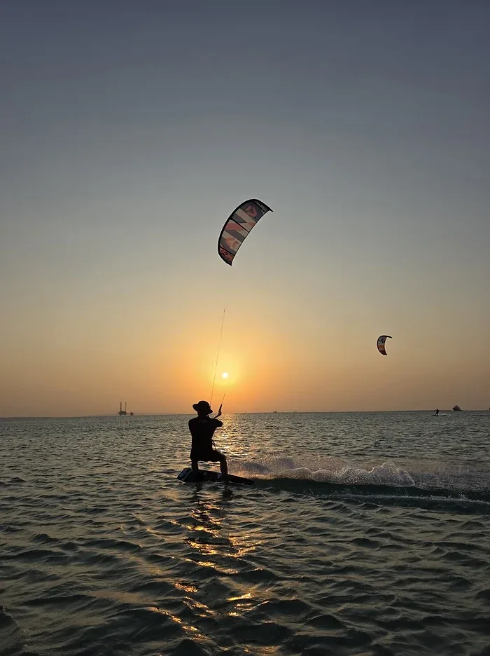 Kitesurfer riding into a Red Sea sunset